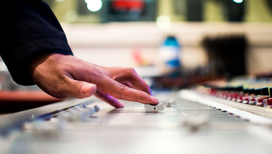 Audio engineer at mixing console